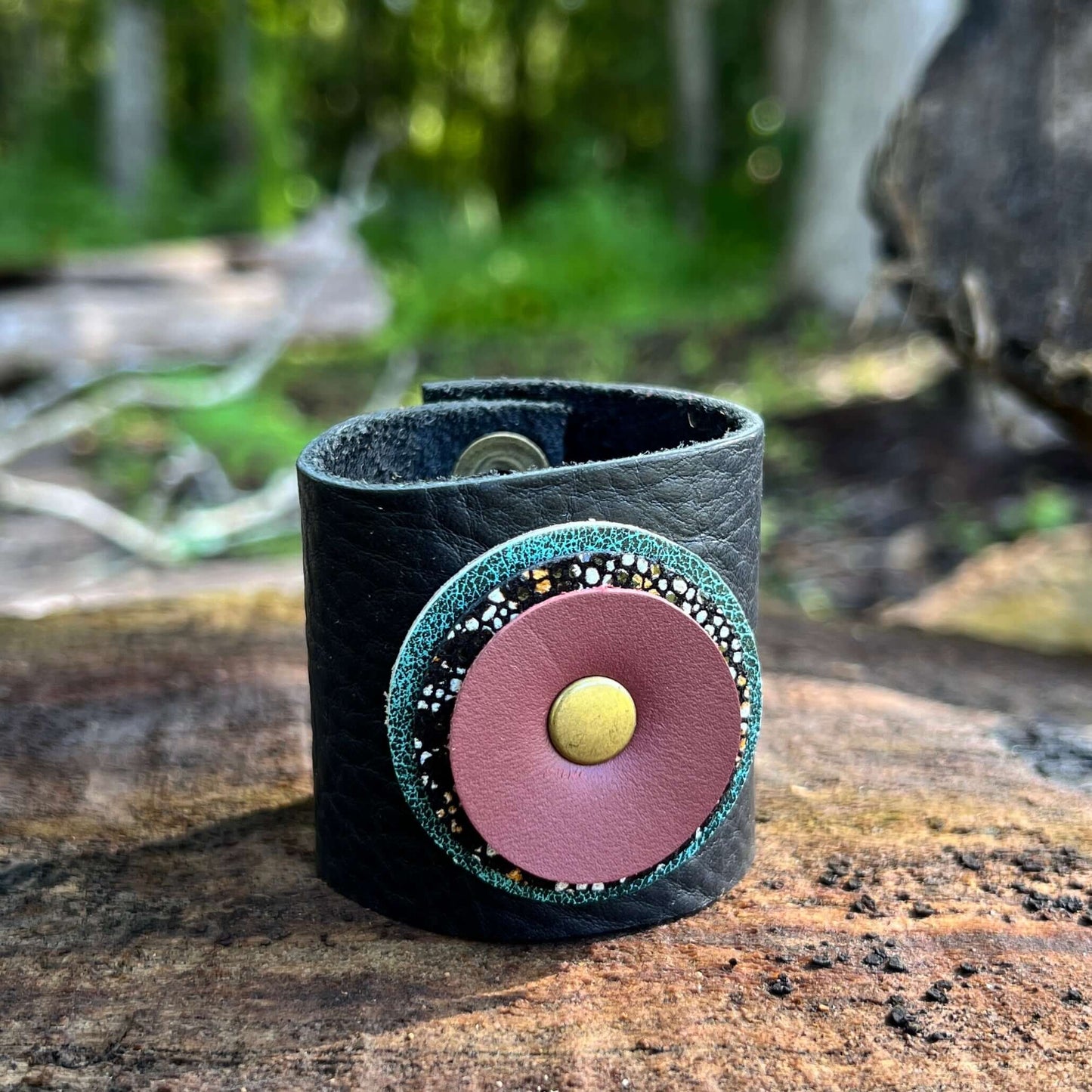 Scarf Cuff for Winter Scarves and Shawls - BlackAccessorize your scarf with a leather scarf cuff. Crafted with genuine leather and accented with a layered leather circle. Double snap closure for a secure wear. 2" wide and snaps closed between 5.5 and 6" F