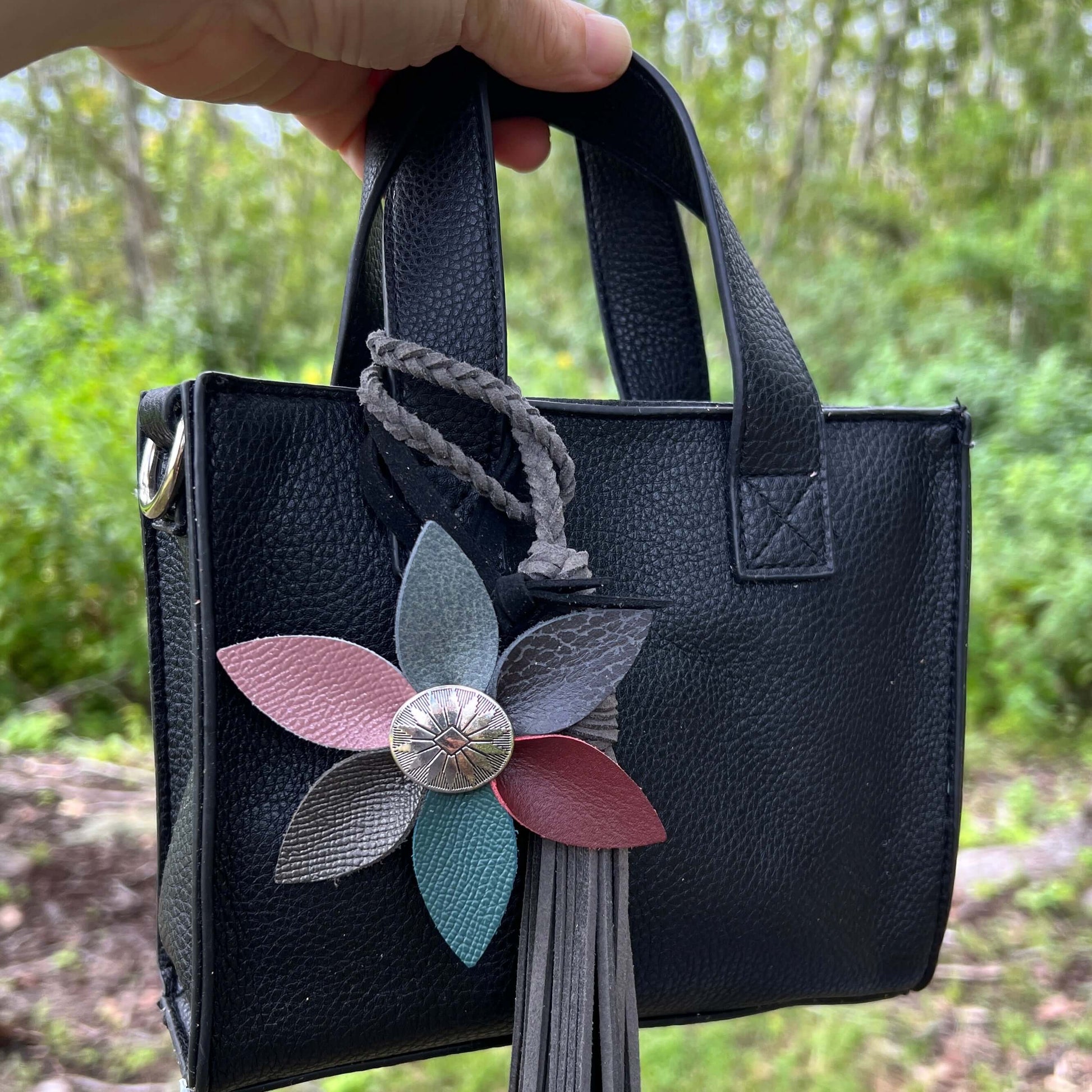 Leather Flower Bag Charm with Tote Loop in Fall Multi ColorBag charms are a great way to update your handbag, purse or tote. Each flower is crafted with leather petals securely sewn and glued together. Silver tone metal button adds a little western flair.