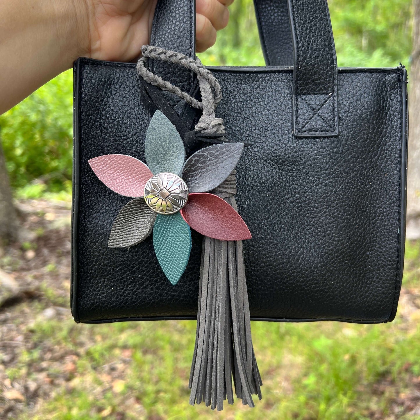 Leather Flower Bag Charm with Tote Loop in Fall Multi ColorBag charms are a great way to update your handbag, purse or tote. Each flower is crafted with leather petals securely sewn and glued together. Silver tone metal button adds a little western flair.