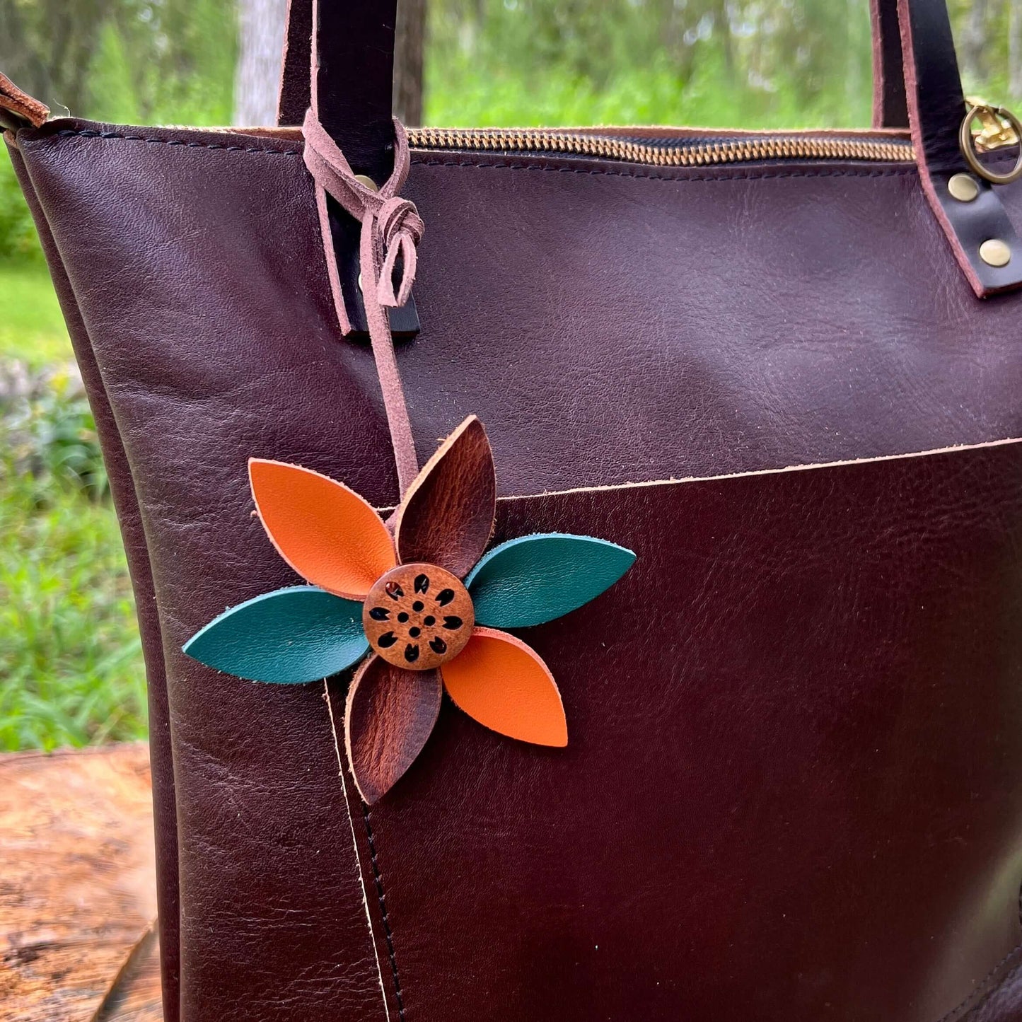 Leather Flower Bag Charm with Tote Loop in Autumn LeavesBag charms are a great way to update your handbag, purse or tote. Each flower is crafted with leather petals securely sewn and glued together. Silver tone metal button adds a little western flair. Fl