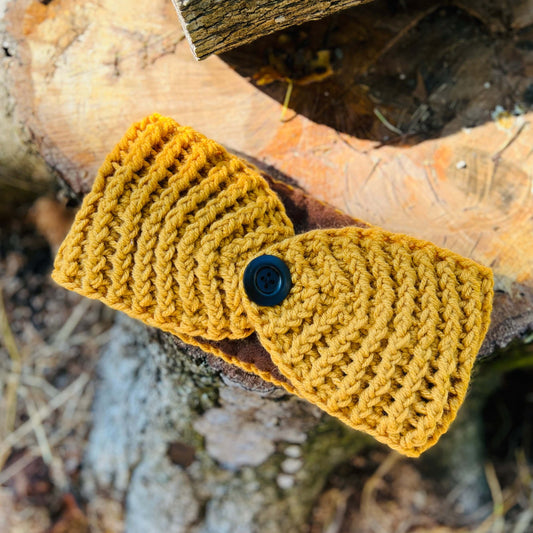 Winter Headband with Fleece Lining - Mustard YellowKeep your ears nice and warm without messing up your do. Crocheted with super soft acrylic yarn and lined with fleece for extra warmth. Button can be worn in the back, front or on the side. 4.75" wide - e