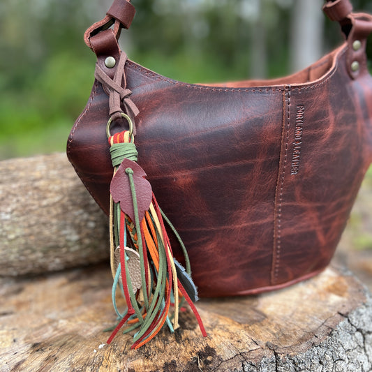 faux suede fringe tassel purse charm with leather feathers and wood beads.