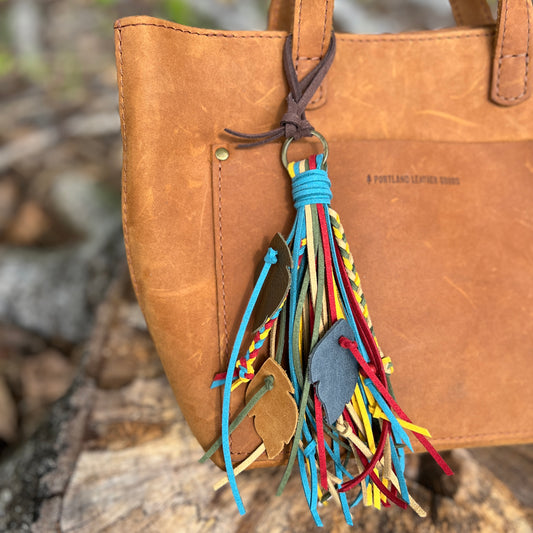 faux suede fringe tassel with braids and leather feathers bag charm on brown tote