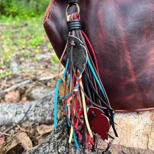 fringe tassel bag charm with leather feathers and wood beads and braids.