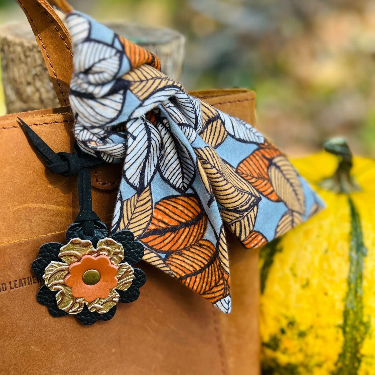 Fall Flannel Leaves Purse Scarf and Leather Flower Bag CharmGive your handbag, purse or tote a fall vibe with a purse scarf or leather flower charm. Cotton flannel scarf in a autumn leaf print looks great alone or add a small leather flower in black, oran