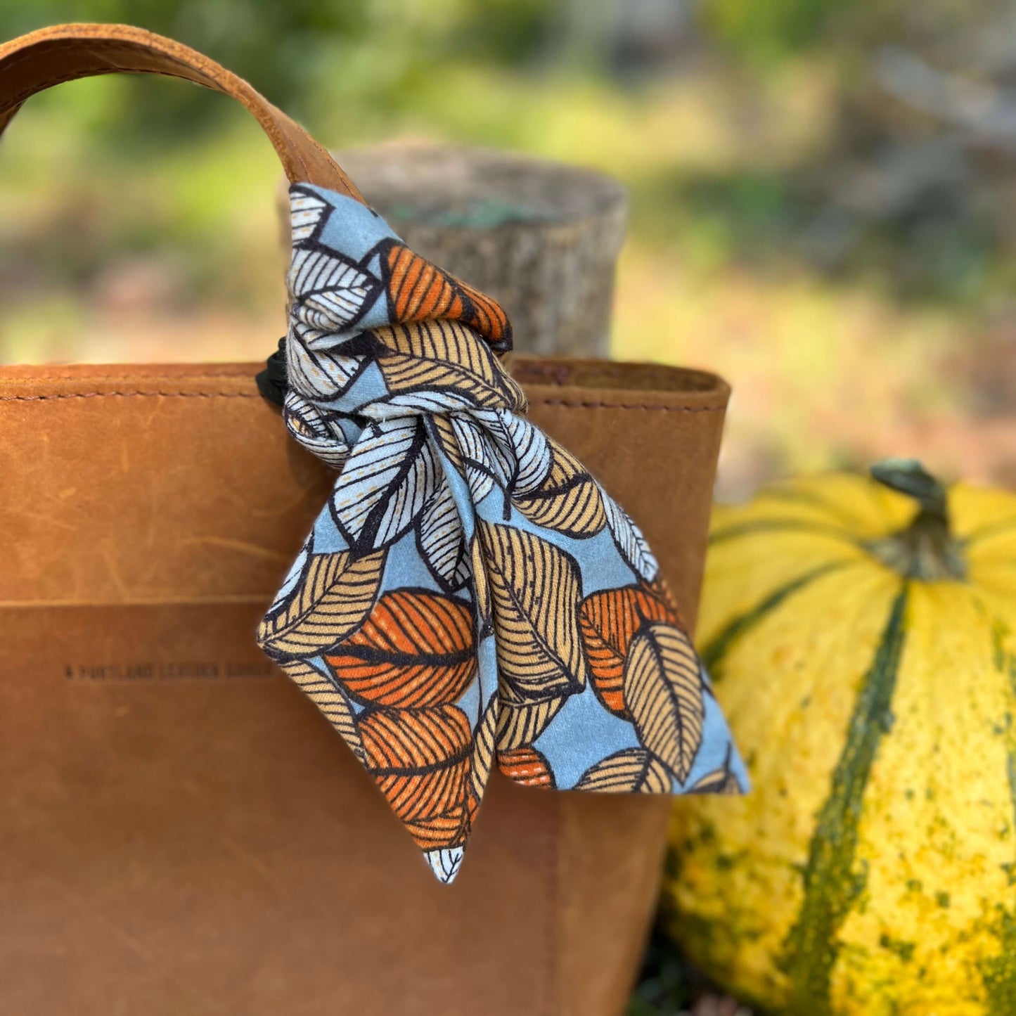 Fall Flannel Leaves Purse Scarf and Leather Flower Bag CharmGive your handbag, purse or tote a fall vibe with a purse scarf or leather flower charm. Cotton flannel scarf in a autumn leaf print looks great alone or add a small leather flower in black, oran