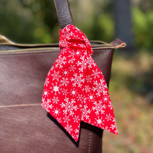 Christmas Flower and Snowflake Scarf Bag CharmGive your handbag, purse or tote a bit of Christmas cheer with a festive purse scarf or leather flower charm. Cotton scarf in a holiday holly print look great alone or add a small leather flower in red, green