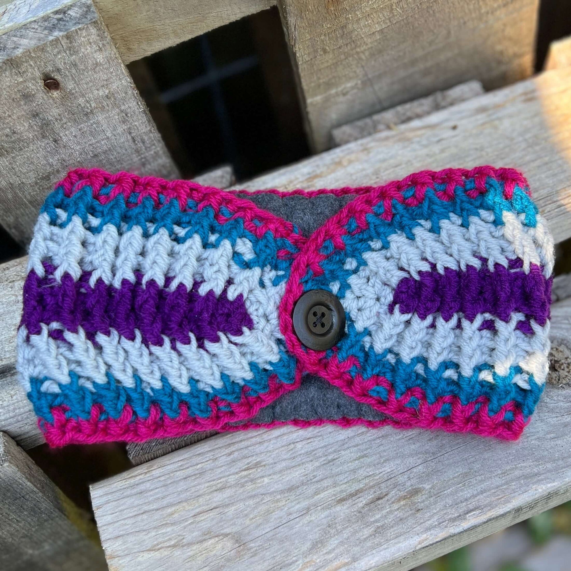 Winter Headband with Fleece Lining - Bright StripesKeep your ears nice and warm without messing up your do. Crocheted with super soft acrylic yarn and lined with fleece for extra warmth. Button can be worn in the back, front or on the side. 4.75" wide - e