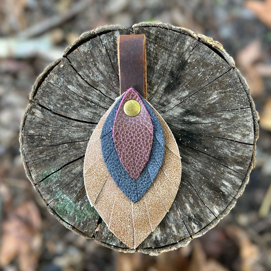 Leather Feather Bag Charm - Brown, Deep Navy and Plum WineLeather feather charms are the perfect way to add a little flair to your handbag, tote or purse. Handcrafted with layers of genuine leather and securely riveted to a leather loop with your choice o