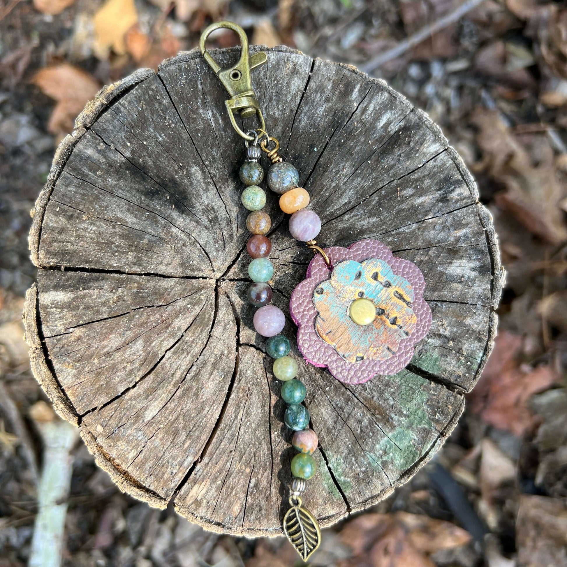 Beaded Bag Charm with Leather FlowerGive your handbag or purse an instant update with a beaded purse charm. Constructed on heavy gauge beading wire with natural stones, bohemian charms and genuine leather flower. - Each charm is between 4.5" length from c