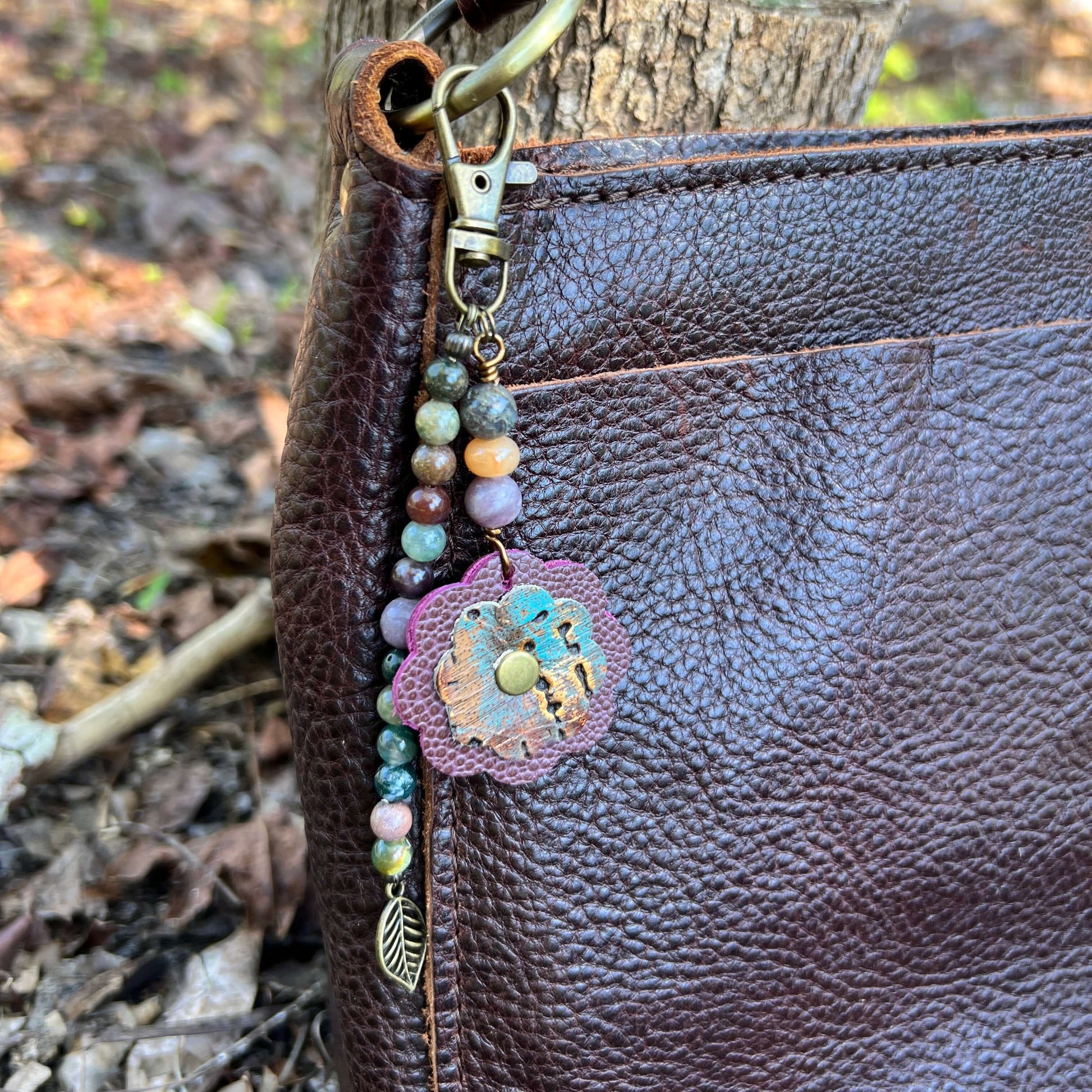 Beaded Bag Charm with Leather FlowerGive your handbag or purse an instant update with a beaded purse charm. Constructed on heavy gauge beading wire with natural stones, bohemian charms and genuine leather flower. - Each charm is between 4.5" length from c