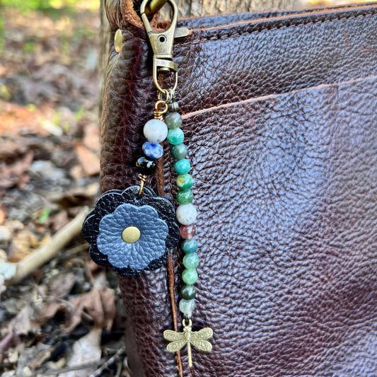 Beaded Bag Charm with Leather FlowerGive your handbag or purse an instant update with a beaded purse charm. Constructed on heavy gauge beading wire with natural stones, bohemian charms and genuine leather flower. - Each charm is between 4.5" length from c