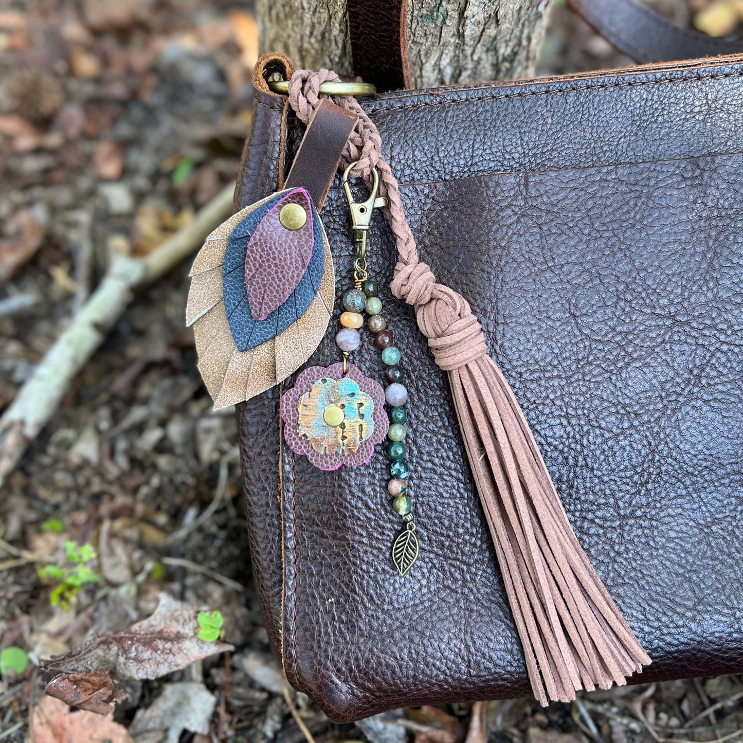 Leather Feather Bag Charm - Brown, Deep Navy and Plum WineLeather feather charms are the perfect way to add a little flair to your handbag, tote or purse. Handcrafted with layers of genuine leather and securely riveted to a leather loop with your choice o