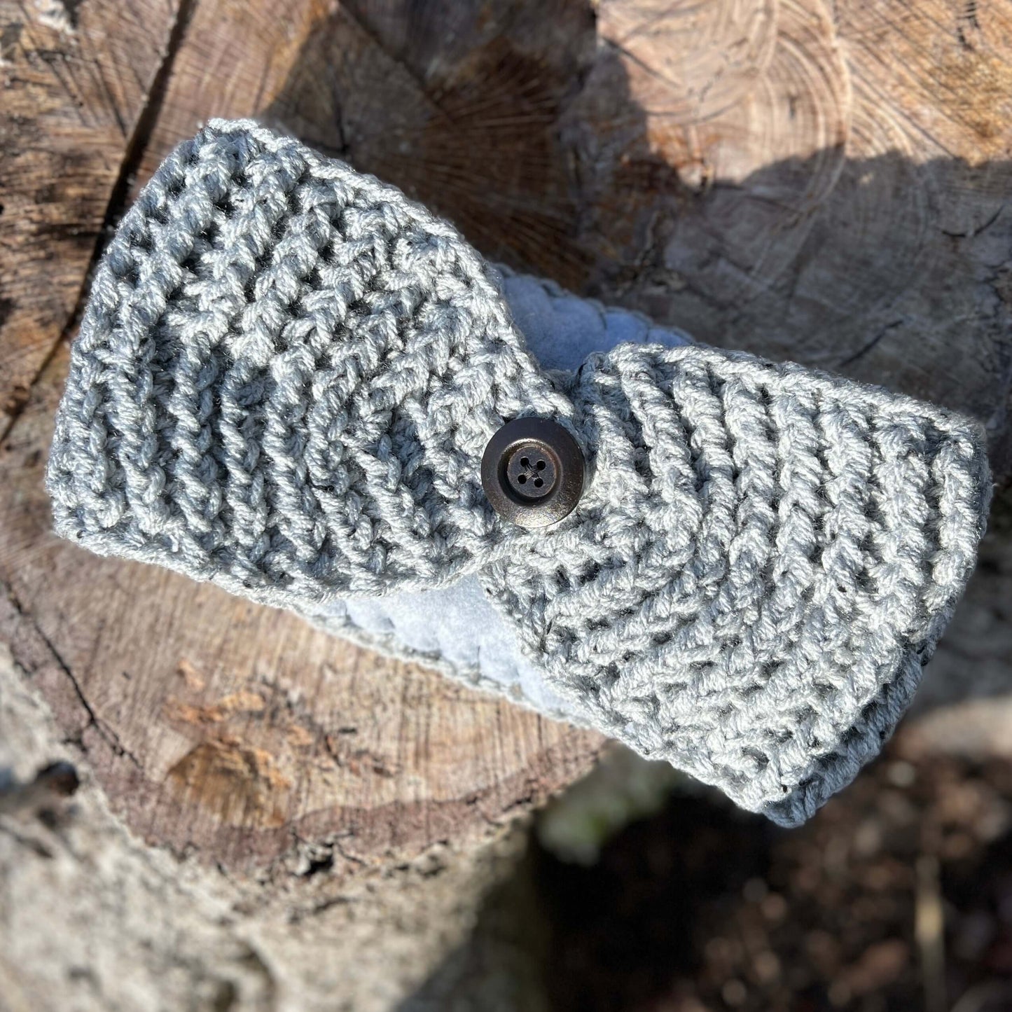 Winter Headband with Fleece Lining and Working Button - Grey TweedKeep your ears nice and warm without messing up your do. Crocheted with super soft acrylic yarn and lined with fleece for extra warmth. Button can be worn in the back, front or on the side.