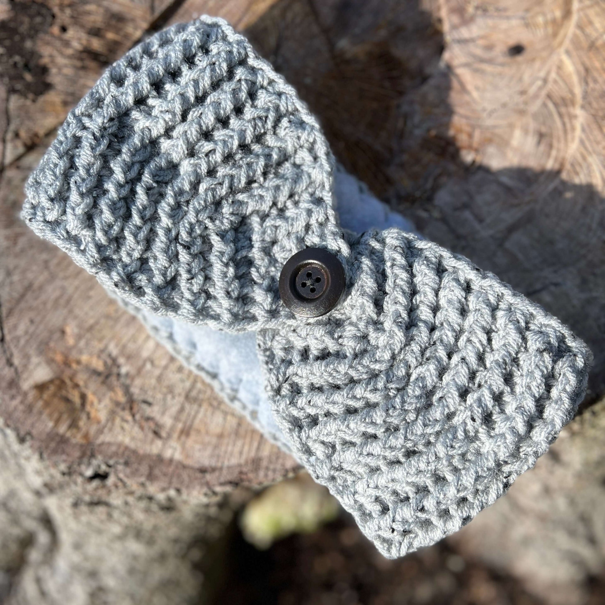 Winter Headband with Fleece Lining and Working Button - Grey TweedKeep your ears nice and warm without messing up your do. Crocheted with super soft acrylic yarn and lined with fleece for extra warmth. Button can be worn in the back, front or on the side.