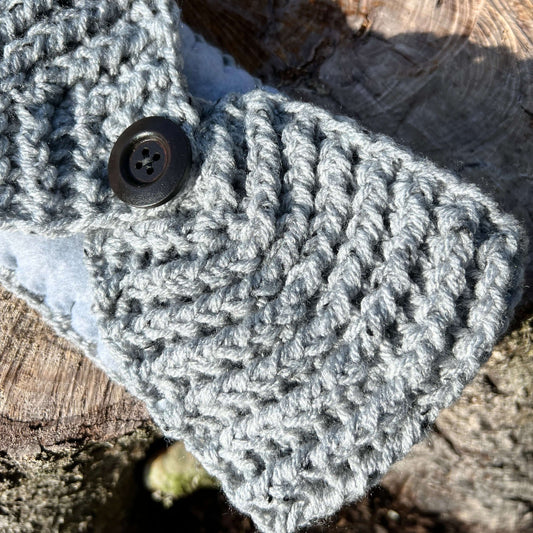 Winter Headband with Fleece Lining and Working Button - Grey TweedKeep your ears nice and warm without messing up your do. Crocheted with super soft acrylic yarn and lined with fleece for extra warmth. Button can be worn in the back, front or on the side.