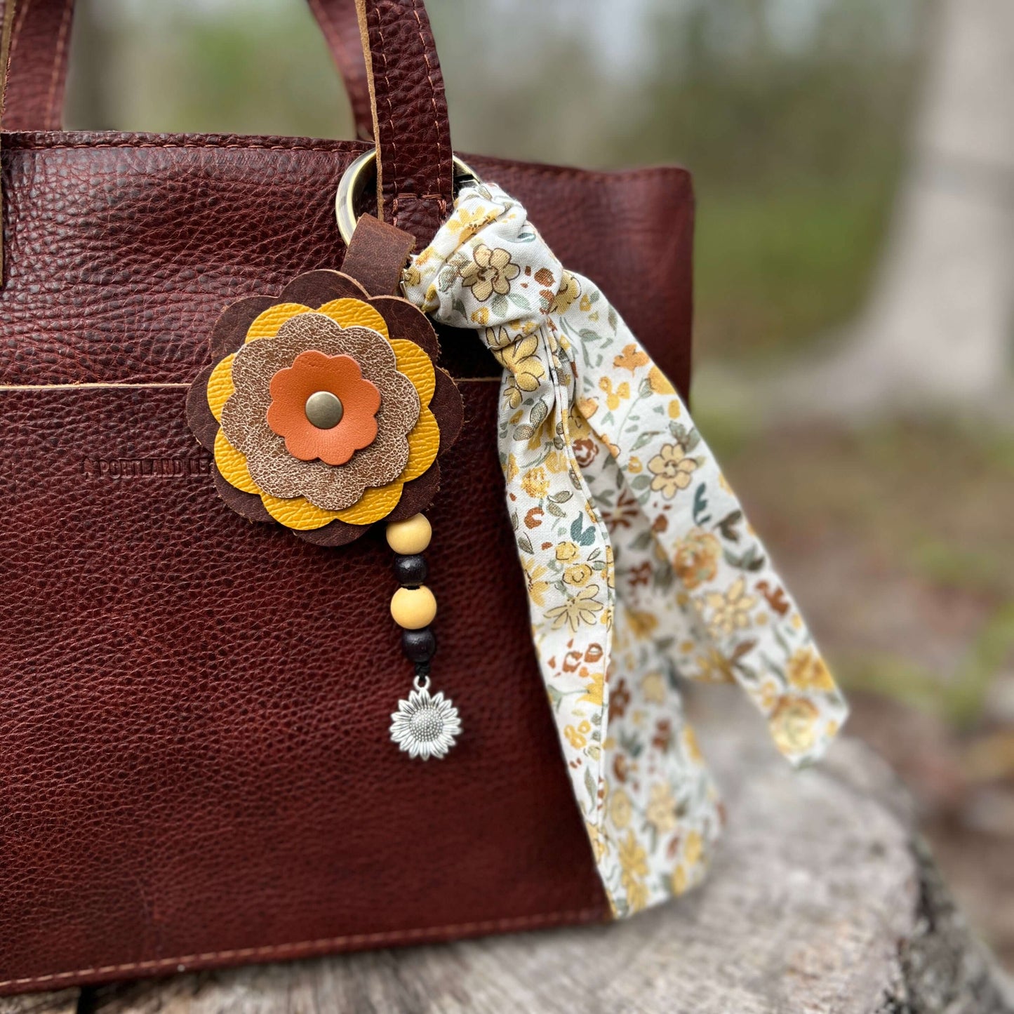 sunflower purse charms shown on brown tote