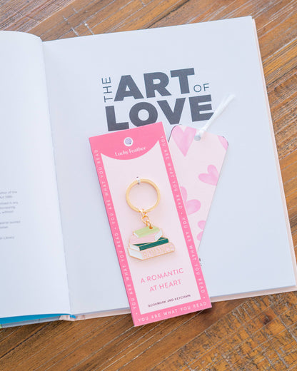 Keychain with packaging on an open book titled 'The Art of Love'.