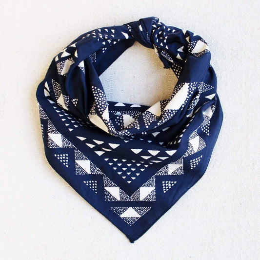 Navy blue bandana with white geometric pattern on a light gray background