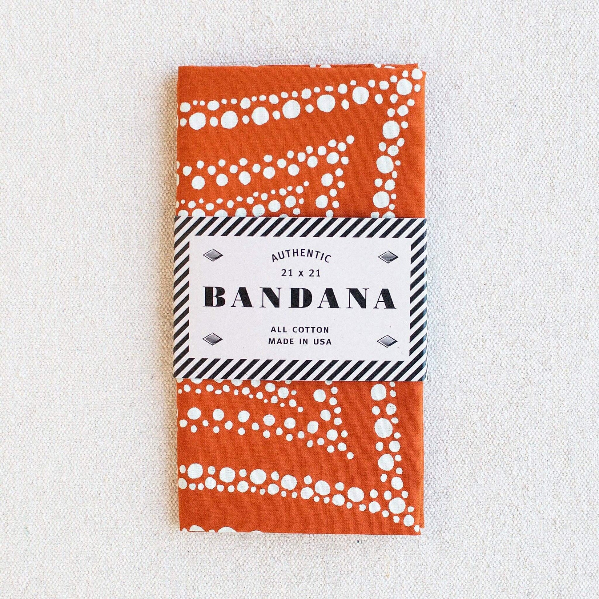 Orange bandana with white patterns on a white background