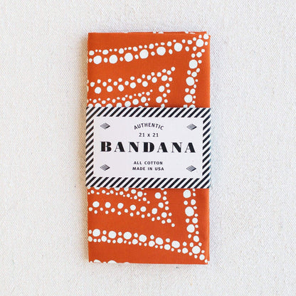 Orange bandana with white patterns on a white background