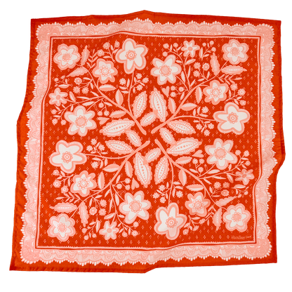Red bandana style scarf with white floral pattern on a white background