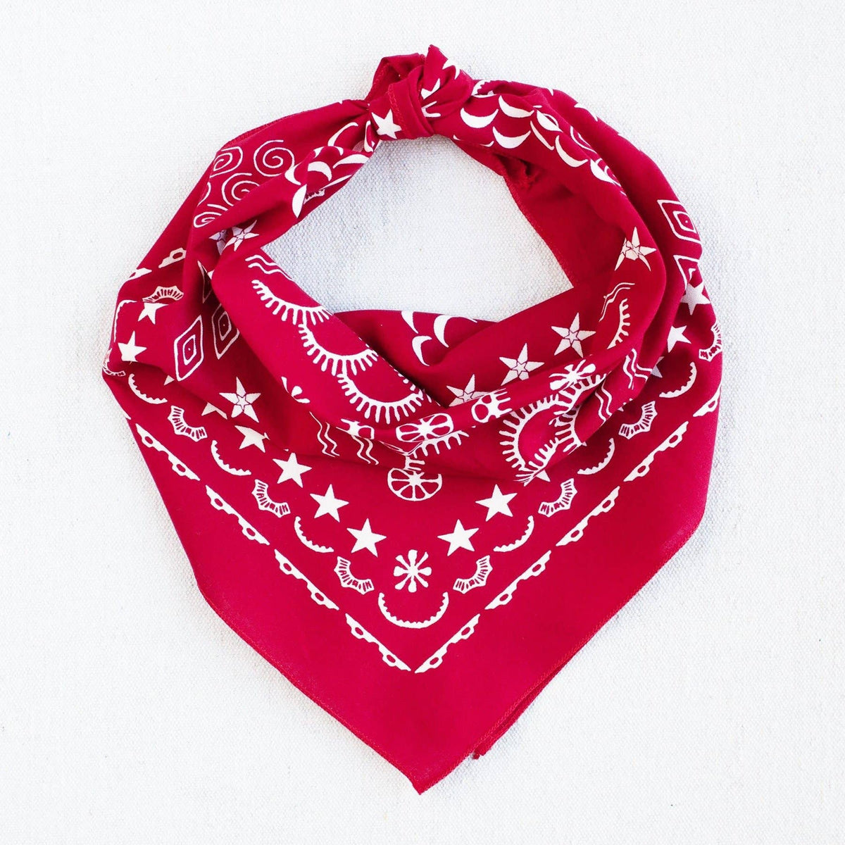 Red bandana with white patterns on a white background