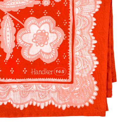 Red bandana style scarf with white floral pattern and 'Handker 145' branding.