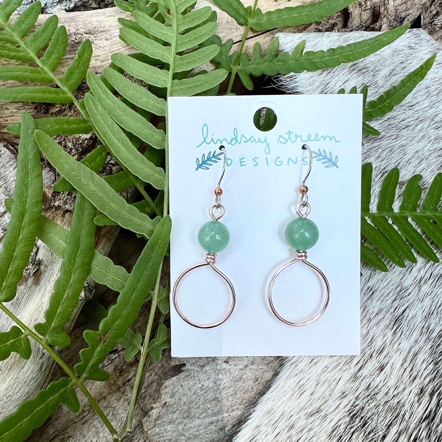 Dangle Hoop Earrings - Rose Gold with Green AventurineSmall hoops are accented with natural stones for chic everyday style. Hoops are hand formed with nickel free and tarnish resistant enameled copper wire. Stone notes: Green Aventurine is provides streng