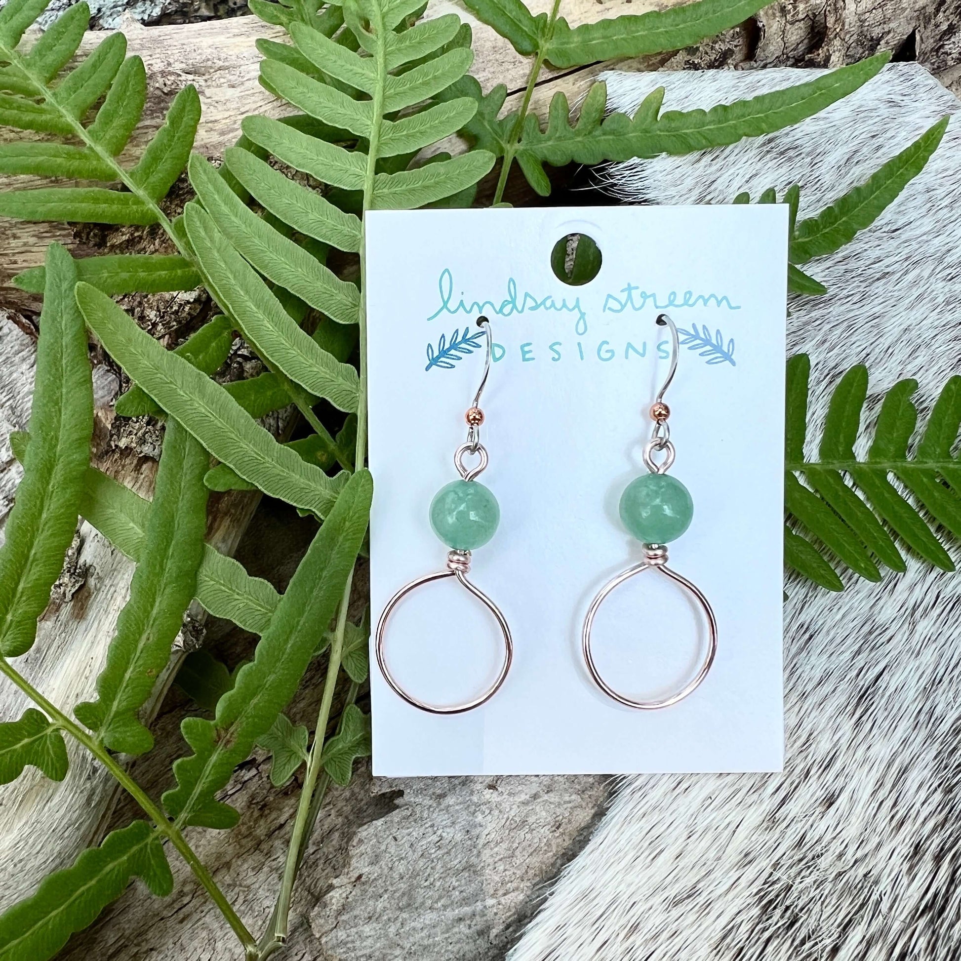 Dangle Hoop Earrings - Rose Gold with Green AventurineSmall hoops are accented with natural stones for chic everyday style. Hoops are hand formed with nickel free and tarnish resistant enameled copper wire. Stone notes: Green Aventurine is provides streng