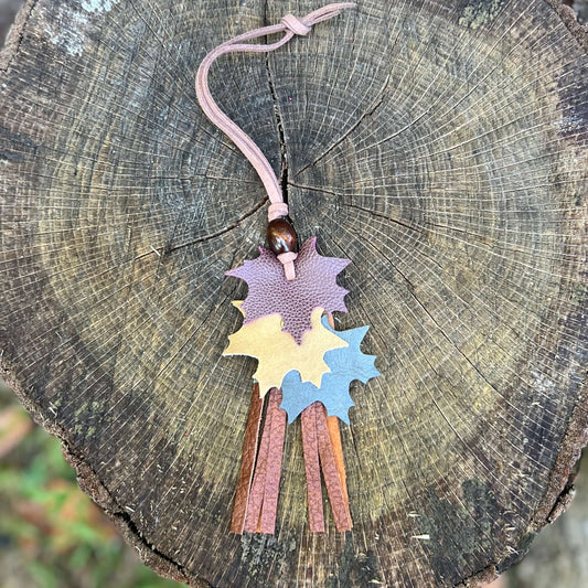 autumn leaves in wine, tan and green with brown leather tassel and wooden bead on brown purse