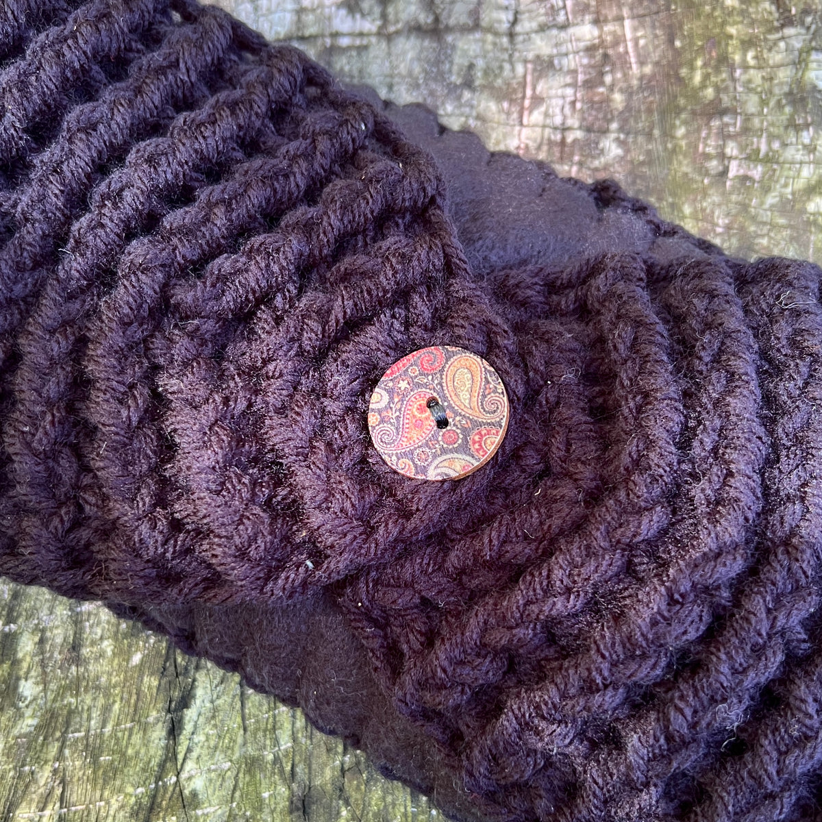 black chunky knit ear warmer with fleece lining and decorative button