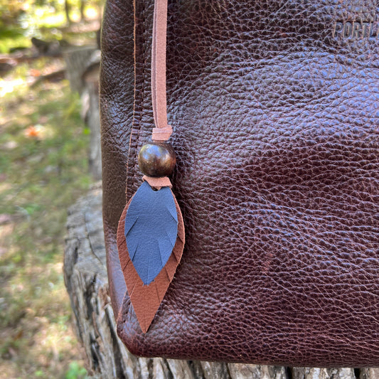 blue and brown leather feather bag charm