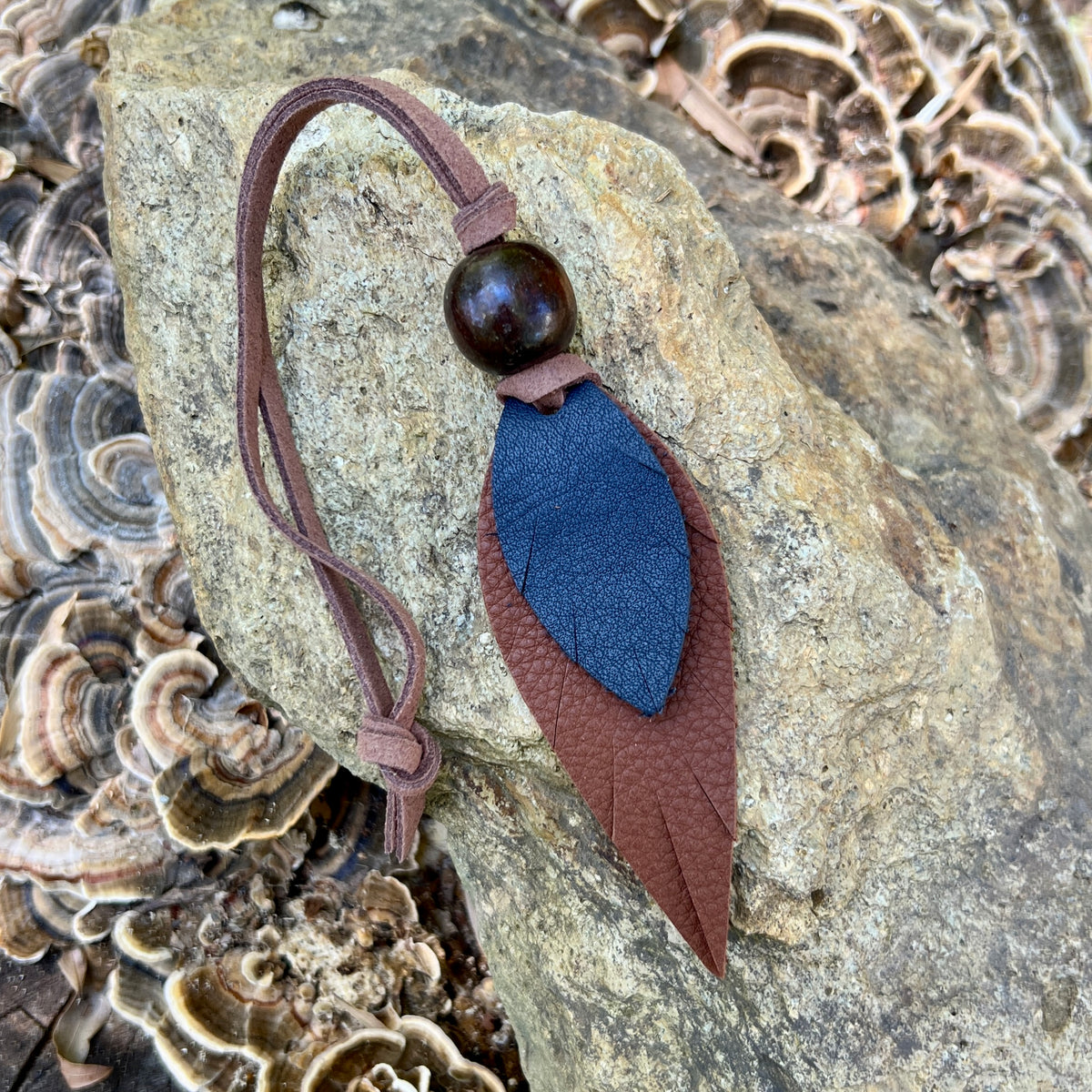 blue and brown leather feather bag charm