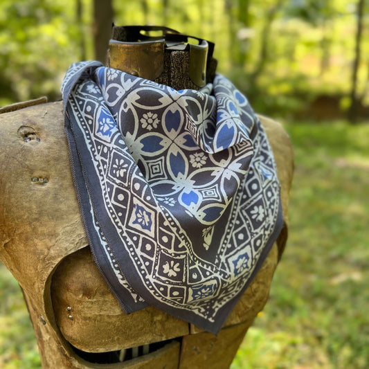 Patterned bandana on a wooden post with a natural background
