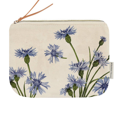 A canvas zippered pouch with a blue and green cornflower floral print on a cream background, featuring a brown leather wrist strap and a small side tag.