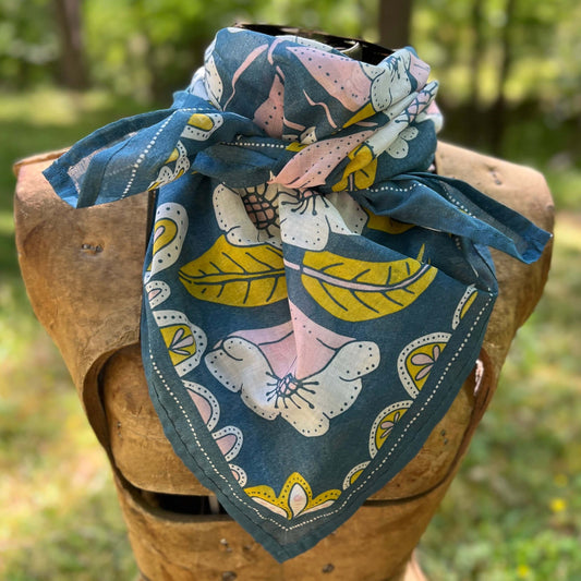 Floral patterned bandana on a wooden block with a natural background