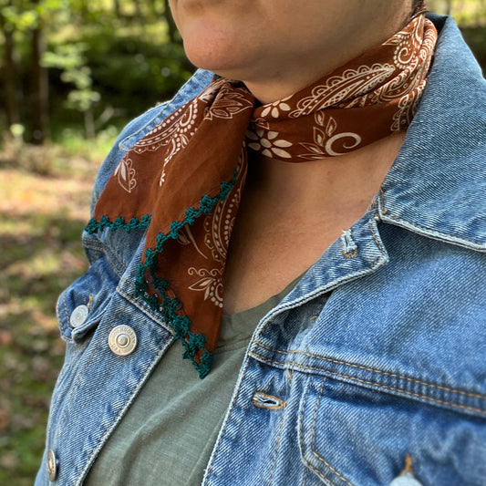 brown and white paisley bandana with blue cotton trim on person