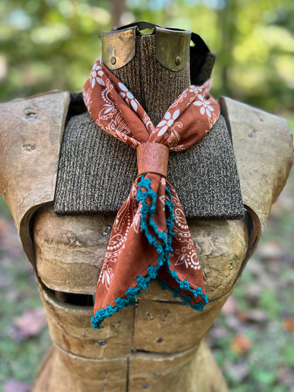 brown and white paisley bandana with blue cotton trim with leather slide