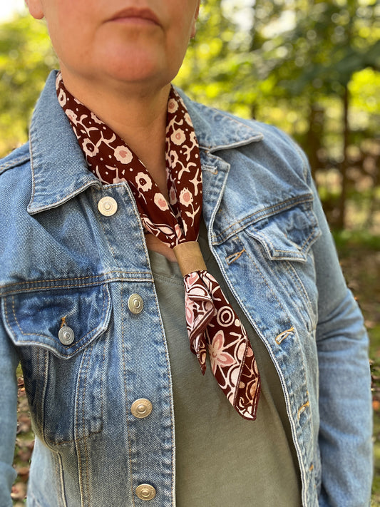 brown floral bandana scarf with leather slide on person with denim jacket