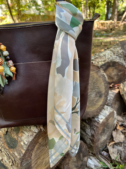 brown, gray and green abstract floral scarf on brown tote