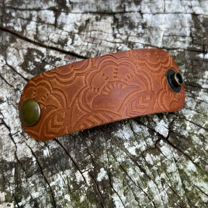 brown leather bandana slide with embossed floral pattern