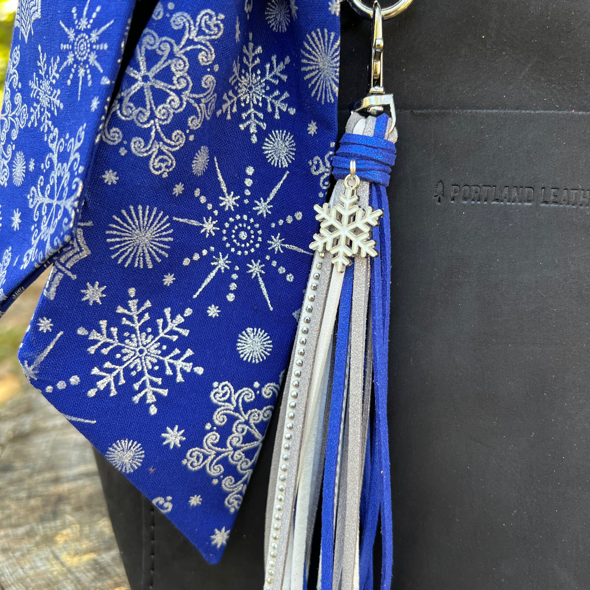 close up of blue and silver snowflake tassel and scarf