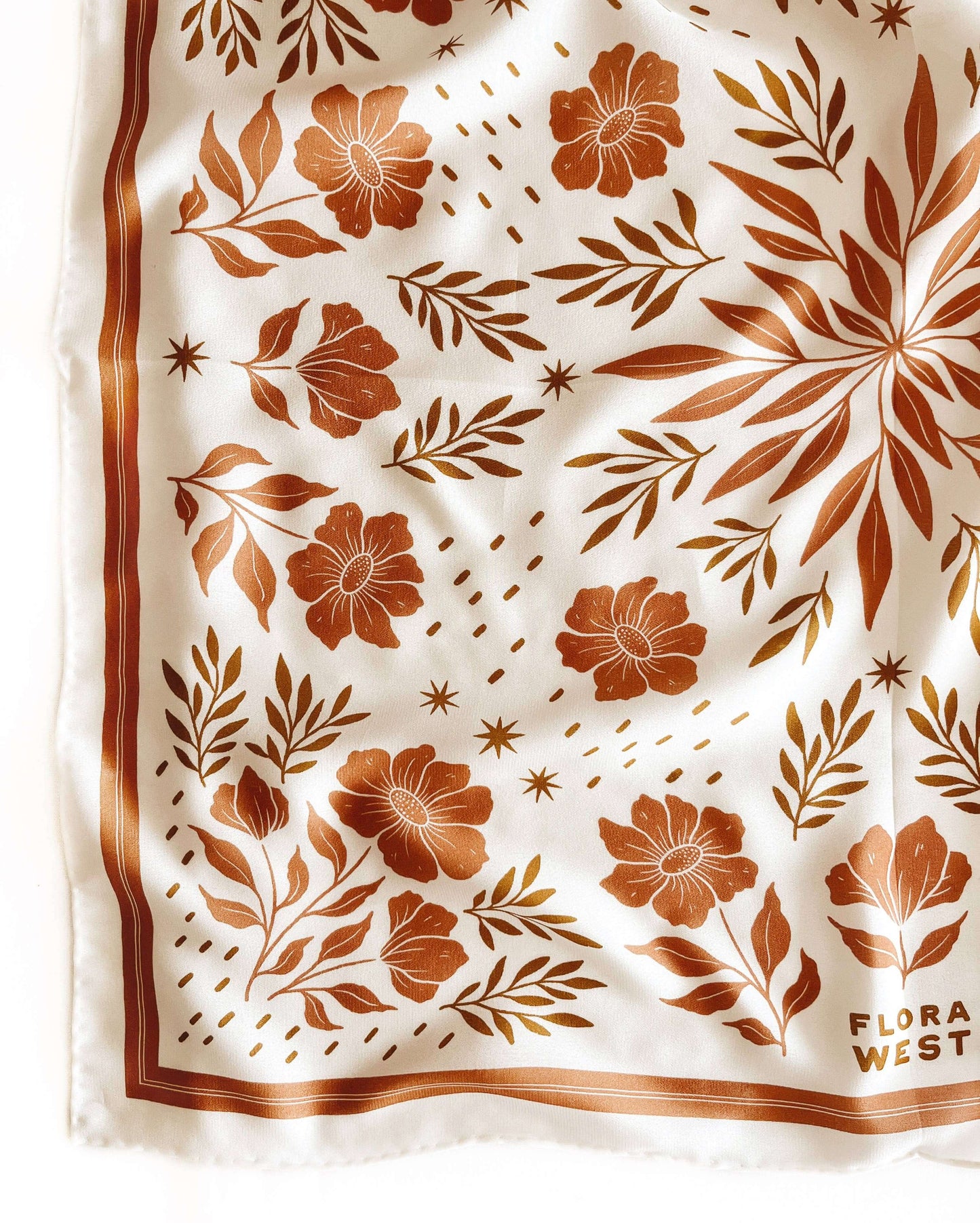Floral patterned fabric with 'Flora West' branding on a white background