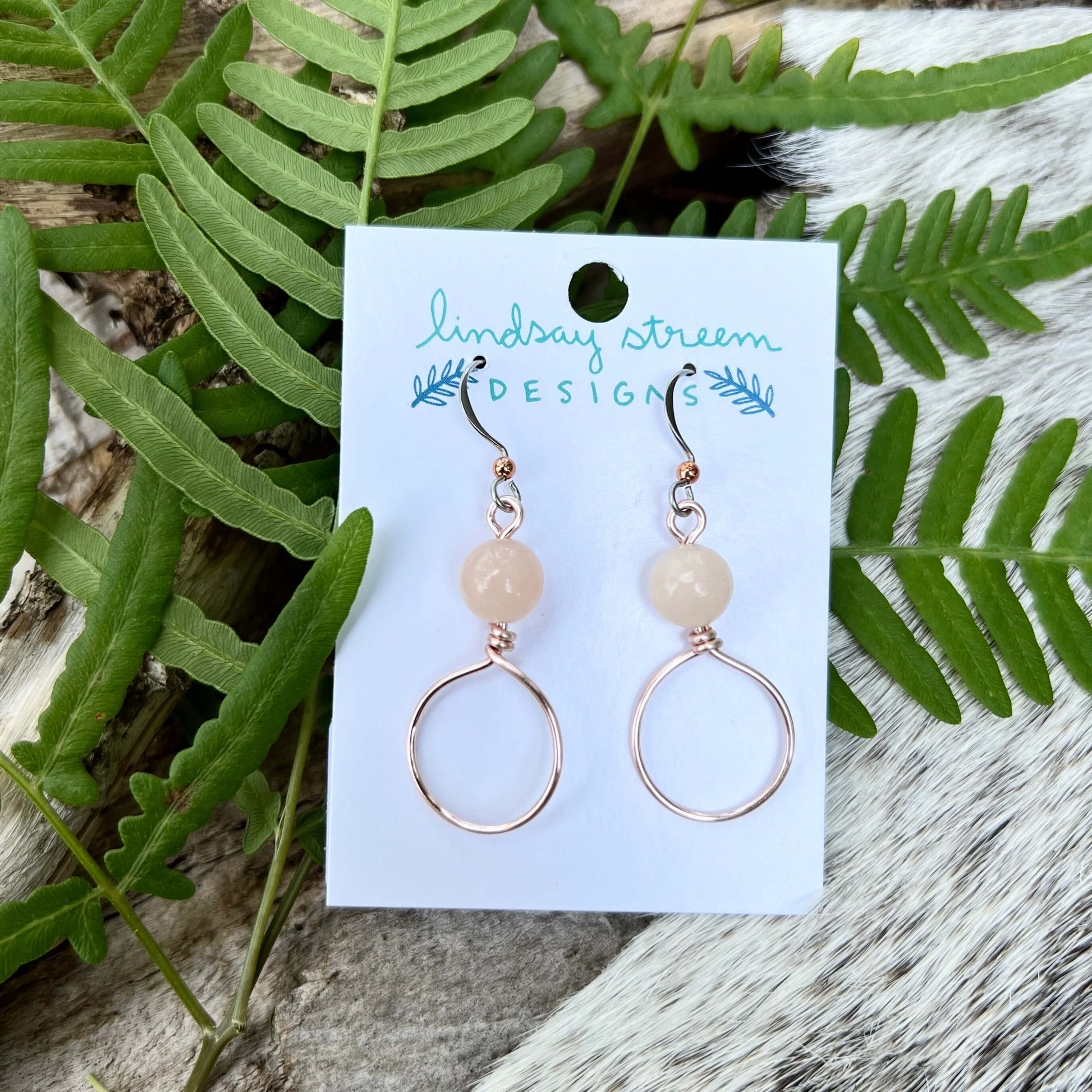 Dangle Hoop Earrings - Rose Gold with Pink AventurineSmall hoops are accented with natural stones for chic everyday style. Hoops are hand formed with nickel free and tarnish resistant enameled copper wire. .75" diameter hoop 1.25" dangle on naturally hypo