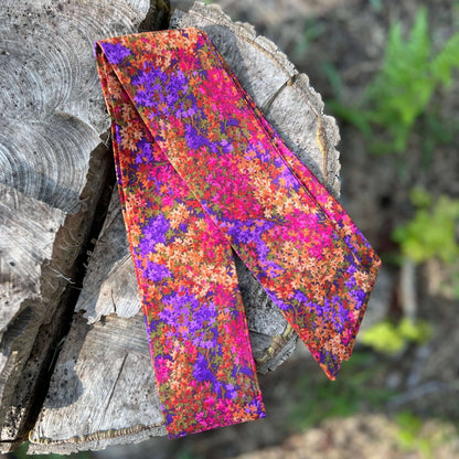 purse scarf on a wooden log 