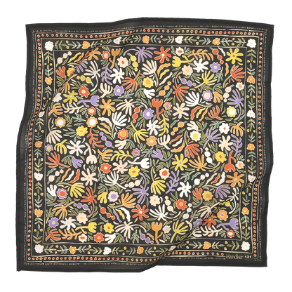 Colorful floral patterned fabric with a black border on a white background