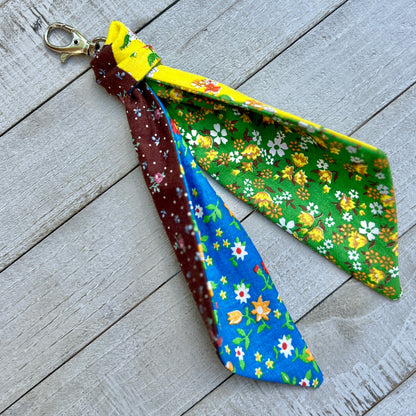Festive keychain with floral patterns on a wooden surface