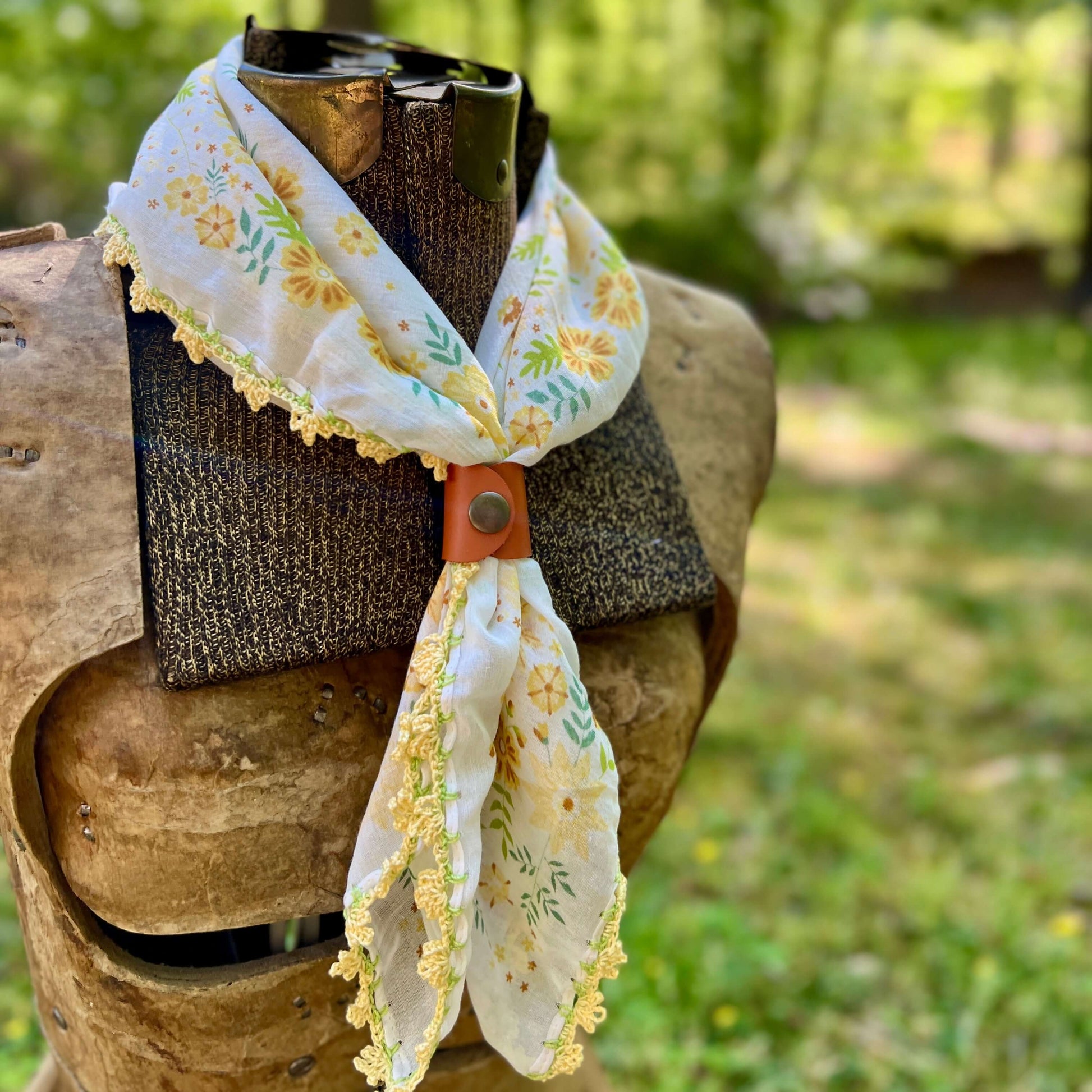 yellow floral bandana with crochet lace edging with leather bandana slide