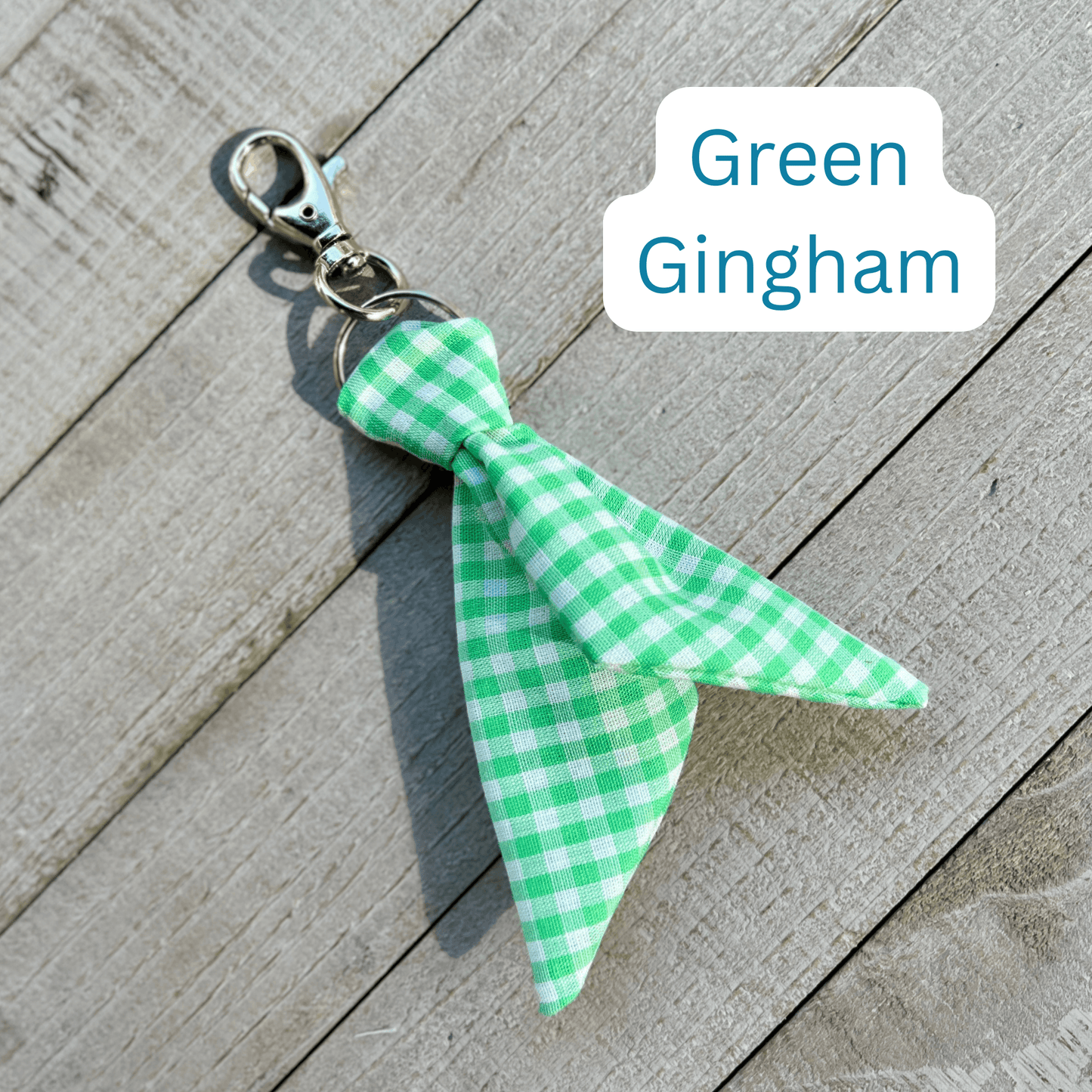 Green gingham bow keychain on a wooden surface with 'Green Gingham' text.
